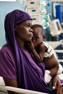 Children's Surgical Hospital. Morning rounds, sub-intensive unit. Elisha Ssegawa, M, 18 months, operated for sacrococcygeal teratoma. Elisha and her mother Namugisha, 33, are from Kiboga, a central district. The mother and father have 5 children, including 2 pairs of twins and are farmers, growing corn and beans. They can only afford to pay the school fees for their first daughter. The others don't go to school. Entebbe, Uganda, 2023