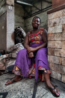 Rose, 45 years old, 5 children and 4 grandchildren, sells coal at the Kitooro market. Entebbe, Uganda, 2023