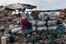 Aisha sells charcoal on the shore of Lake Victoria. Entebbe, Uganda, 2023