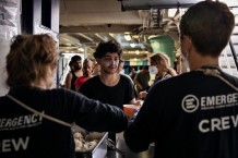 Lunch distribution to the 65 survivors aboard the EMERGENCY SAR Life Support ship. Menu of the day: rice with almonds and lentil soup. On duty are logistician Paula Virallonga, Dr. Paola Tagliabue and cultural mediator Mariam Bouteraa.